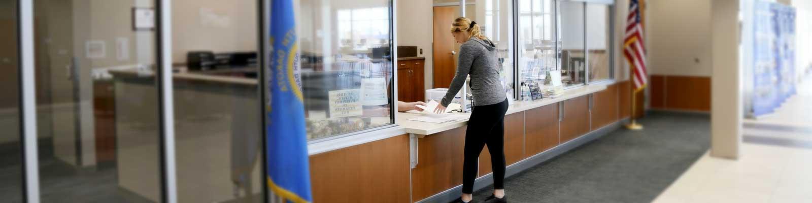 Student conducting a transaction at the business office